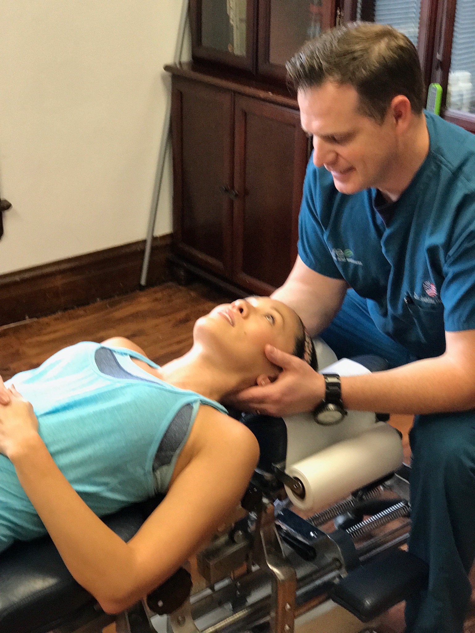 Dr. Hunter supporting a patient's head and neck during a gentle cervical adjustment