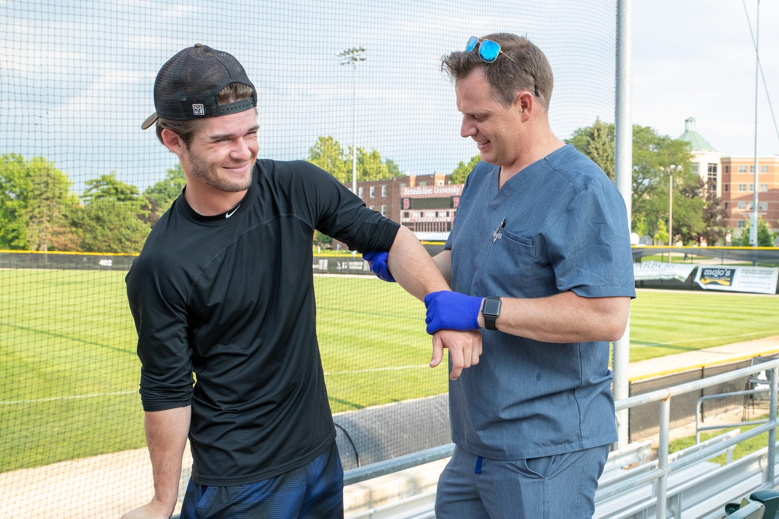 Dr. Justin Hunter treating a Pistol Shrimps athlete on the sideline in Naperville